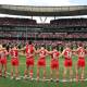 
Swans and Giants players, coaches and umpires form a circle as a show of support against gender-based violence before the round eight AFL match at the SCG on May 4. Picture Getty Images