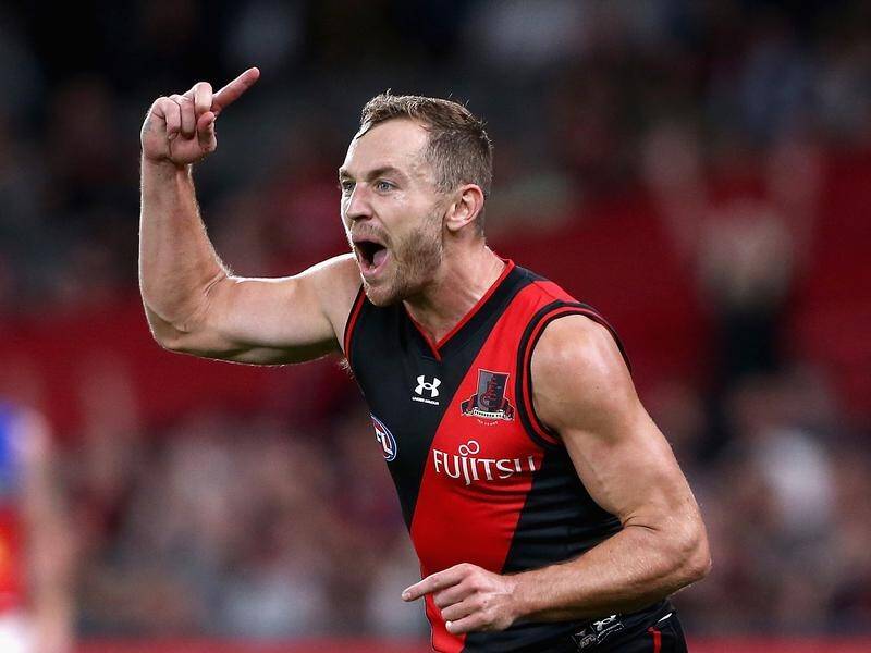 Devon Smith's return is the only change in Essendon's team to face Richmond in the Dreamtime clash.