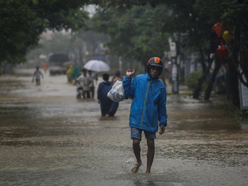 Heavy rain in Vietnam has triggered floods and landslides, with 18 people missing, some feared dead.